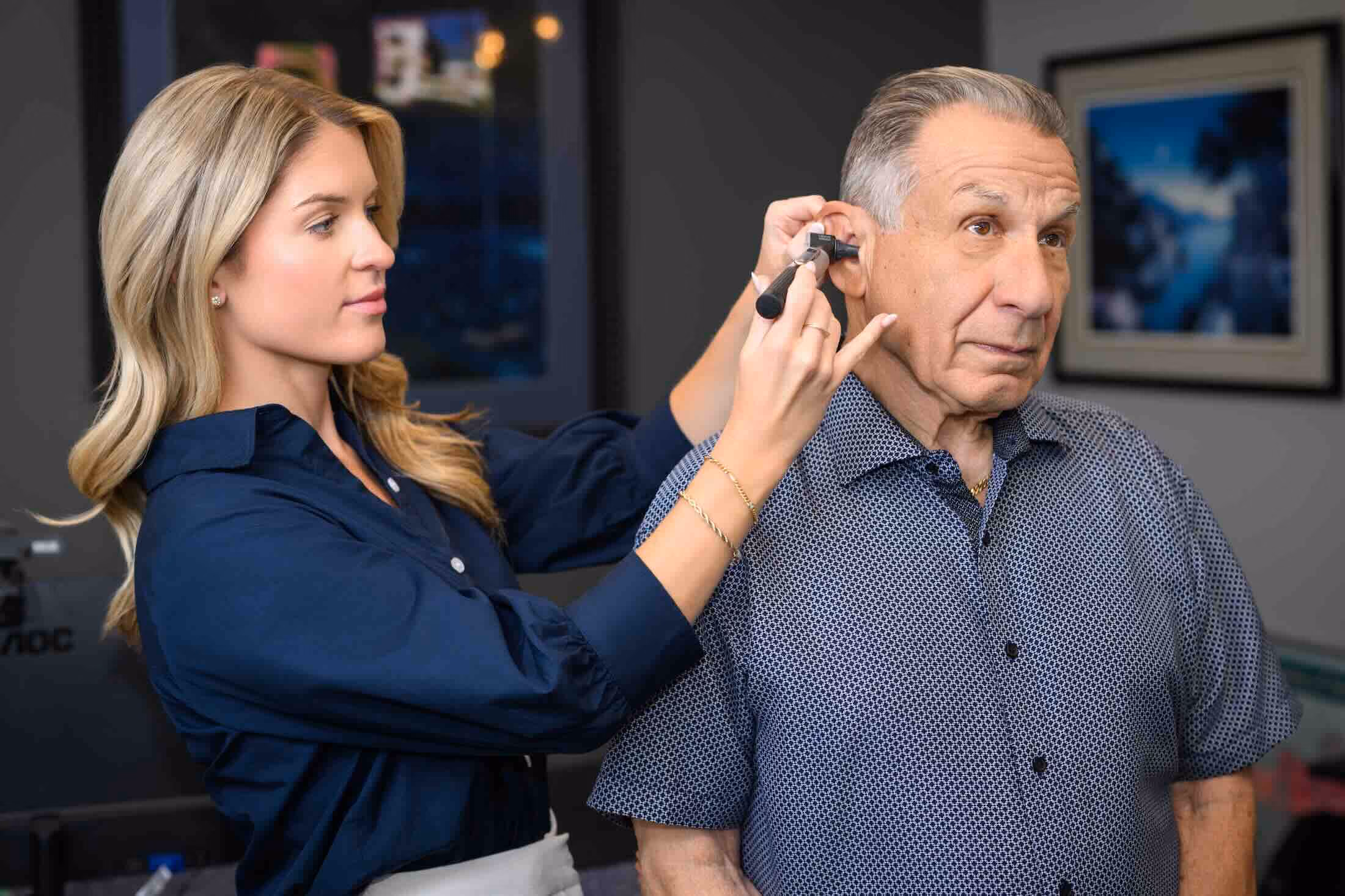 Audiologist Dr. Paige Wendling fitting a patient's device