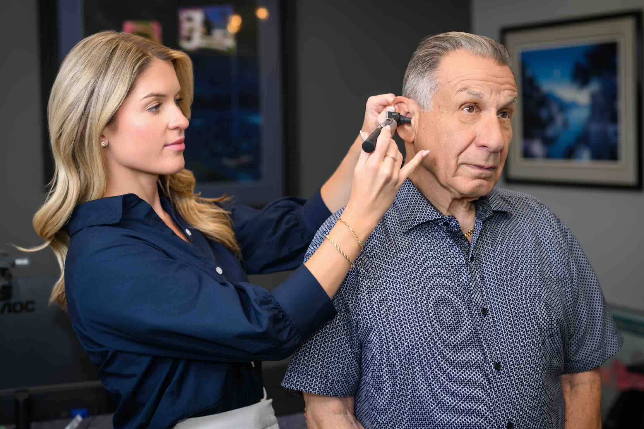 Audiologist Dr. Paige Wendling fitting a patient's device