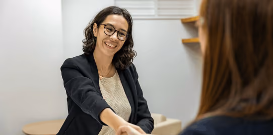 Hiring manager and candidate shaking hands after a successful placement