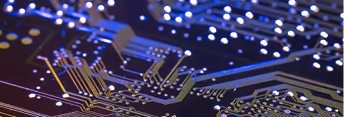 Close-up of a printed circuit board with illuminated signal traces