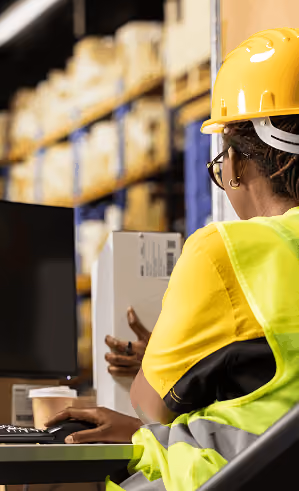 Logistics worker managing inventory in a warehouse