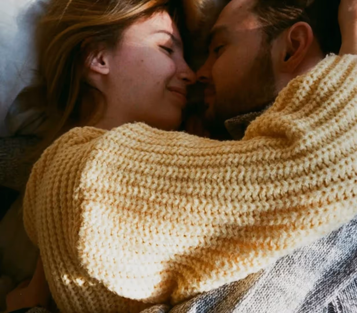 a smiling couple lying down