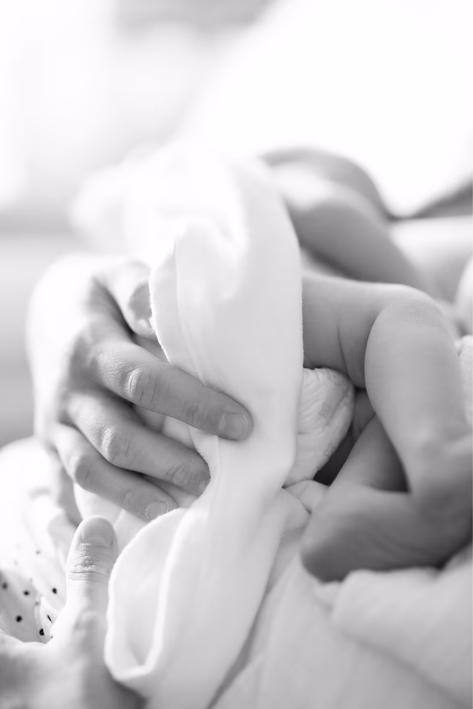 the hands of a woman and a child