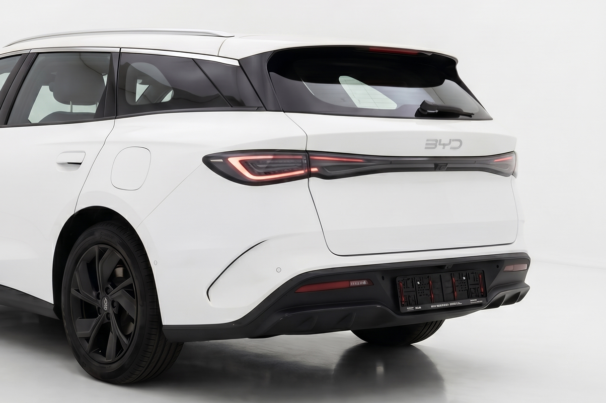 Rear side view of a white BYD electric SUV with black wheels and modern taillights.