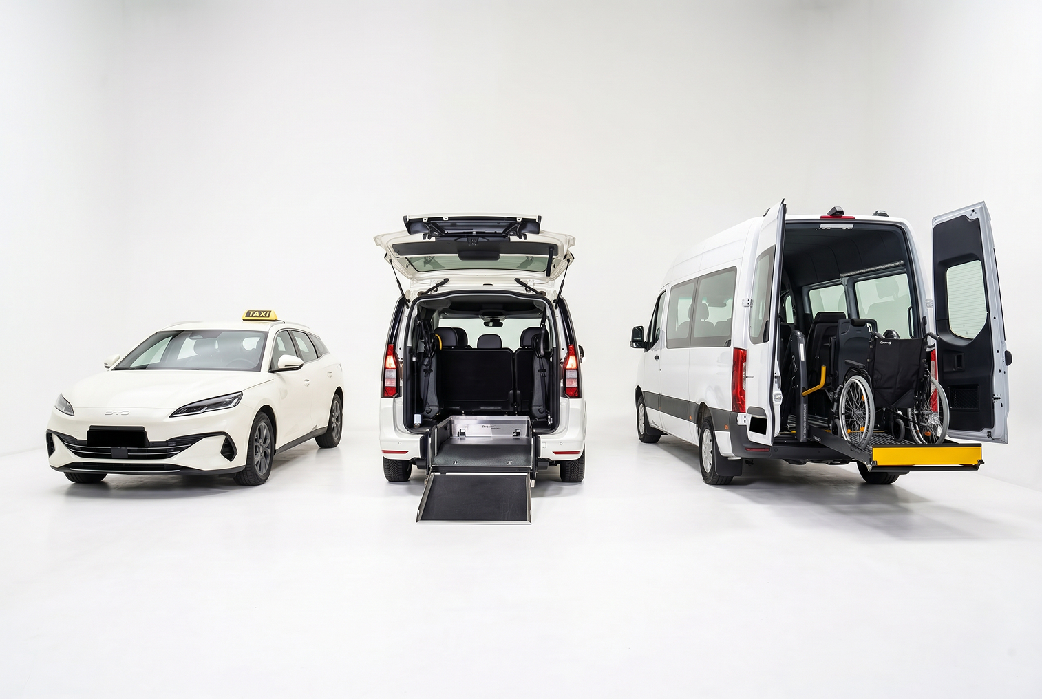 Three white accessible vehicles with rear ramps and wheelchair lift in a white studio space.