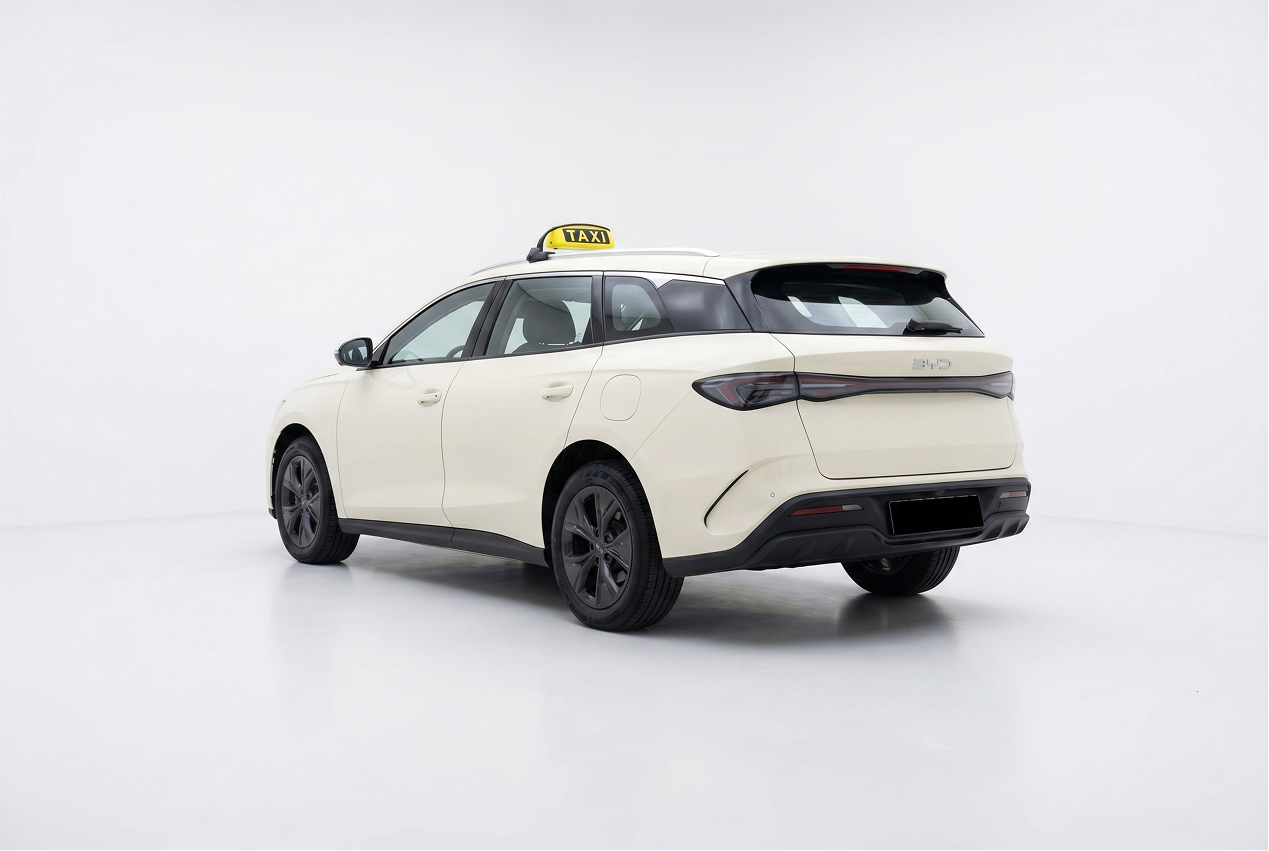 White BYD electric station wagon car with a yellow taxi sign on the roof in a white studio.