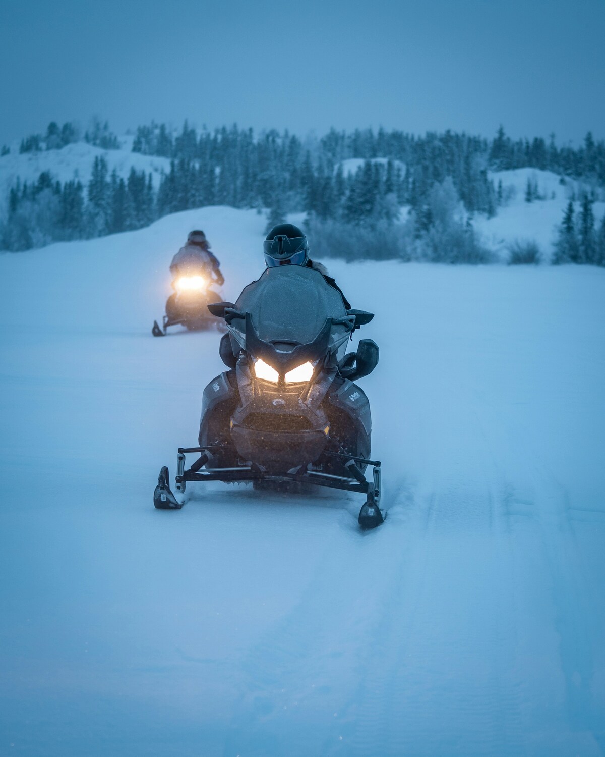 Snowmobile safari through Arctic winter scenery in Lapland