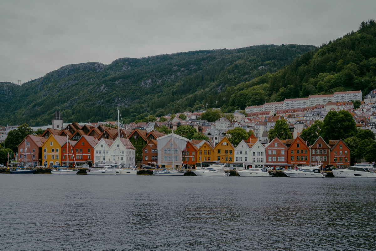 Colourful Bryggen wharf houses and moored boats in Bergen
