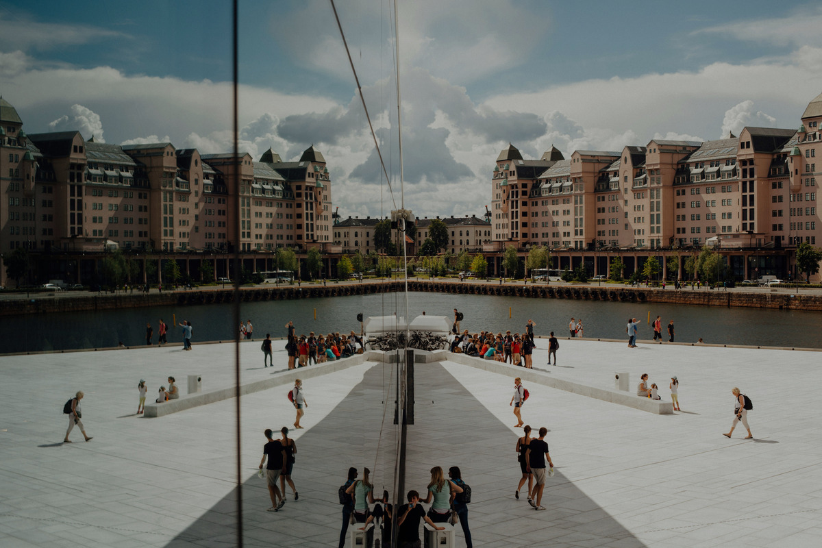 Visitors walking on the marble roof of the Oslo Opera House