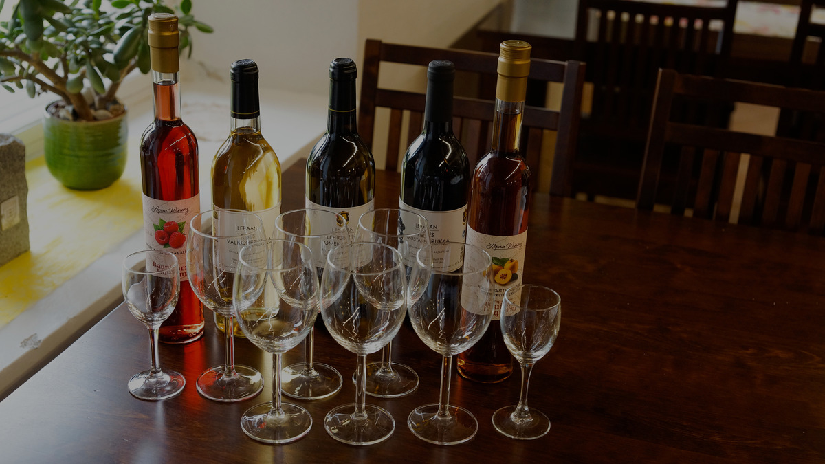 Bottles of Finnish berry wine with tasting glasses