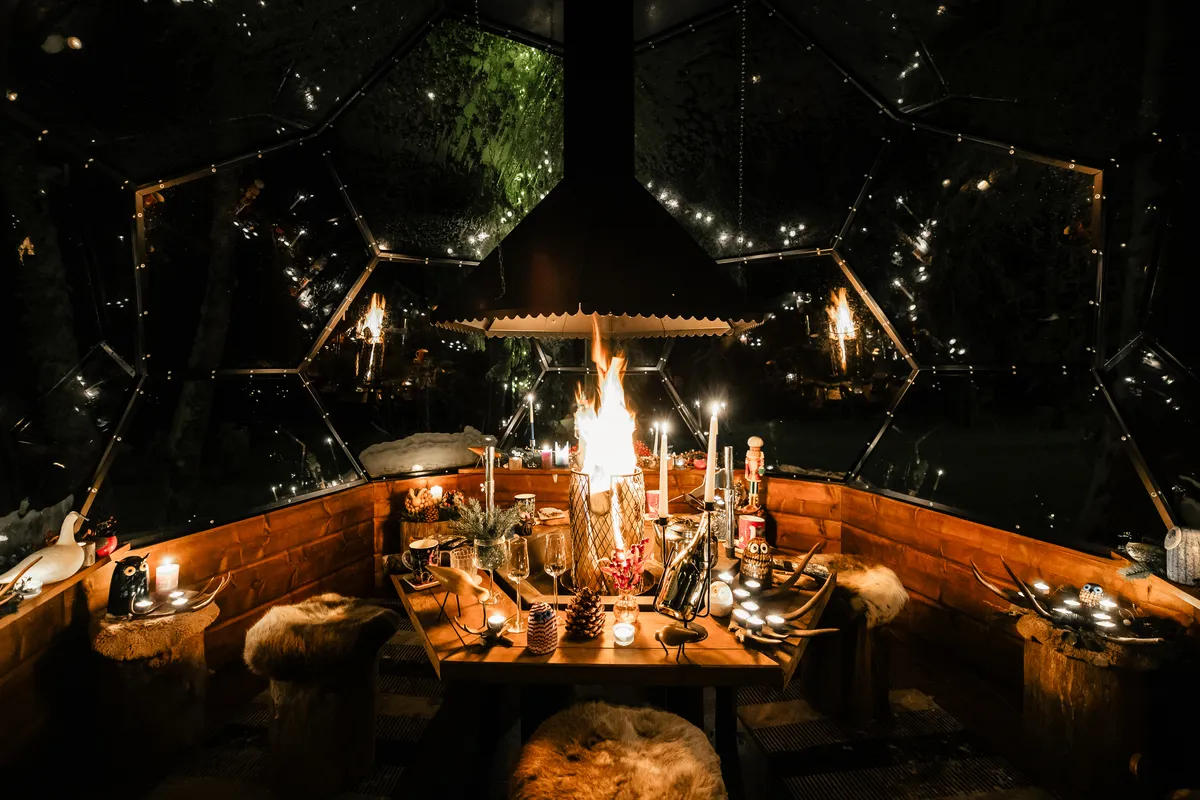A private Arctic evening from Rovaniemi with pickup, glass igloo dinner, thermal gear and a guided snowmobile or ATV ride through the winter forest in search of the Northern Lights.