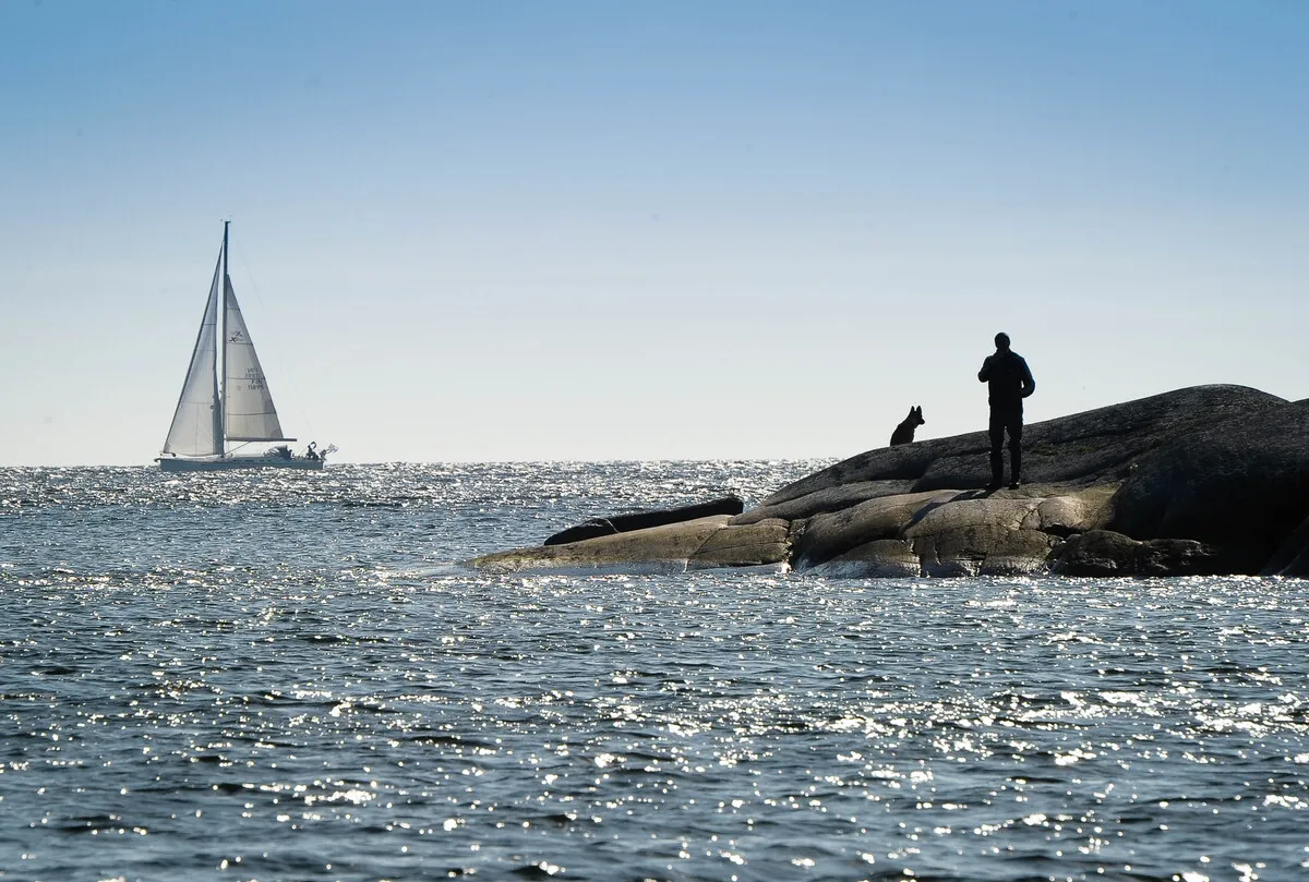 Sailing boat and island scenery seen from the water near Helsinki
