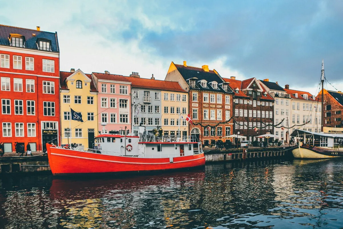 Colourful historic buildings and boats along Nyhavn in Copenhagen