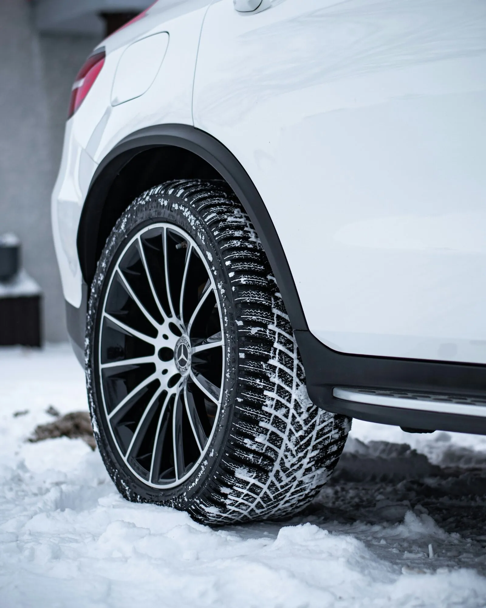 Winter tyre fitted to a vehicle on a snowy road
