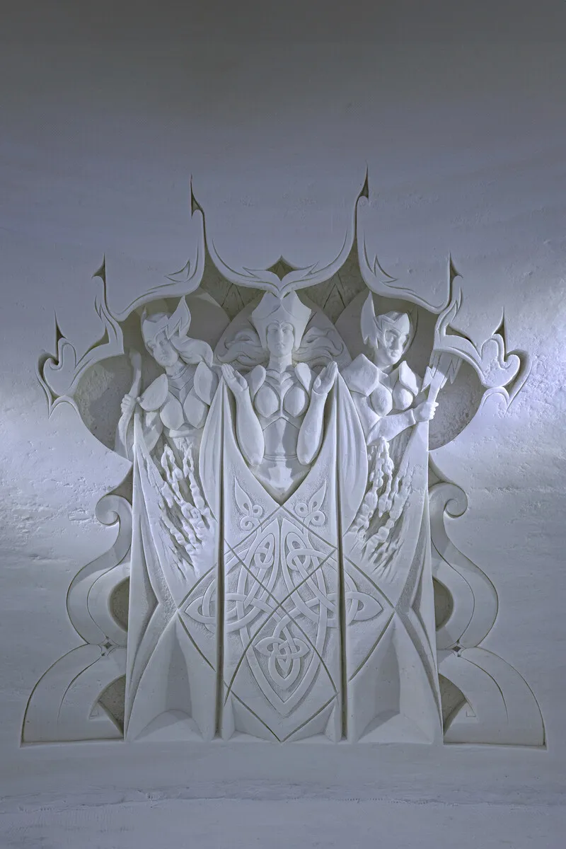 Illuminated ice throne framed by an arch and patterned snow walls