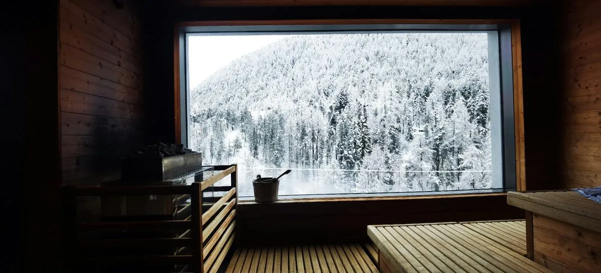 Private Finnish sauna with panoramic views of a snowy Lapland forest
