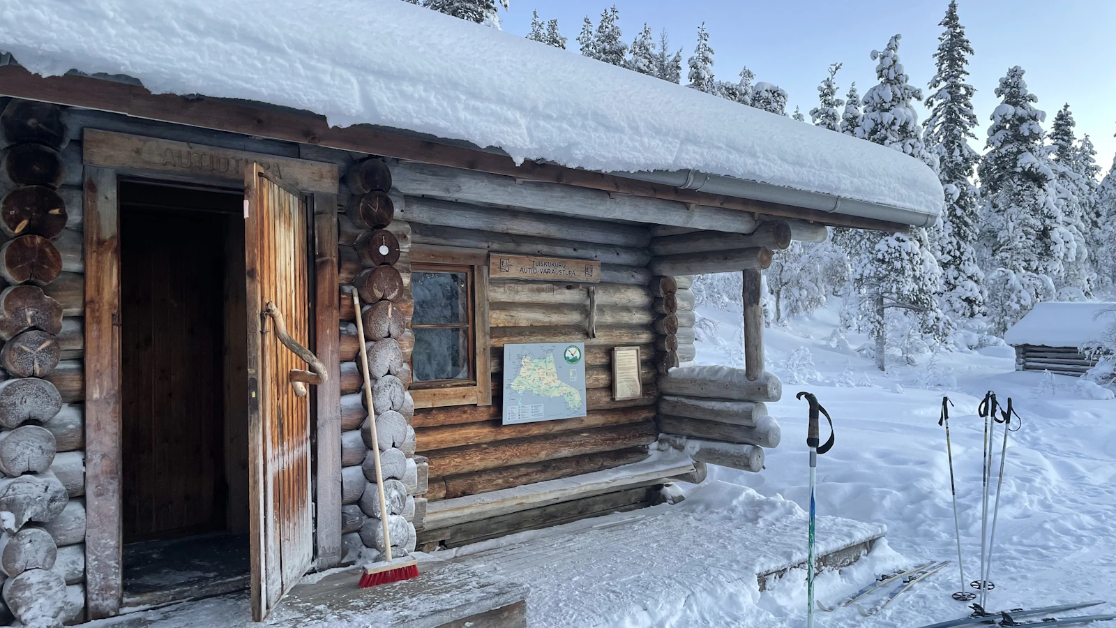 Snow-covered log wilderness hut at Kiilopää in Urho Kekkonen National Park in winter