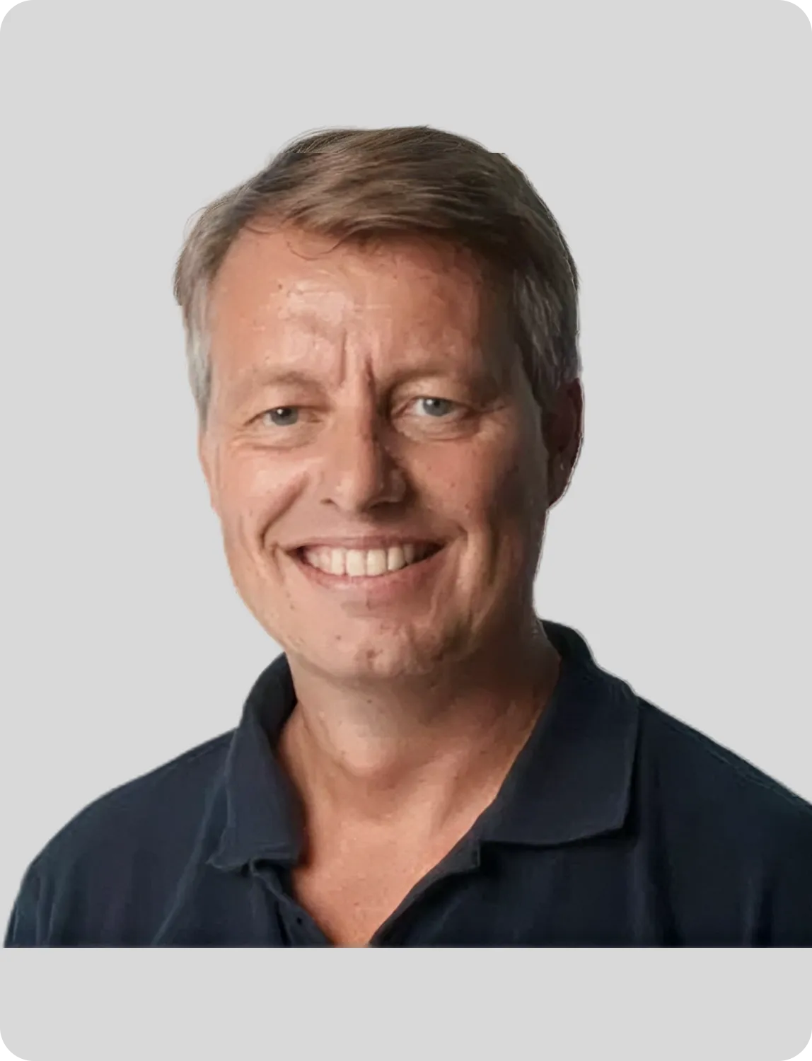 Junge Ärztin mit blondem Pferdeschwanz hält ein leeres Klemmbrett und schaut freundlich in die Kamera.