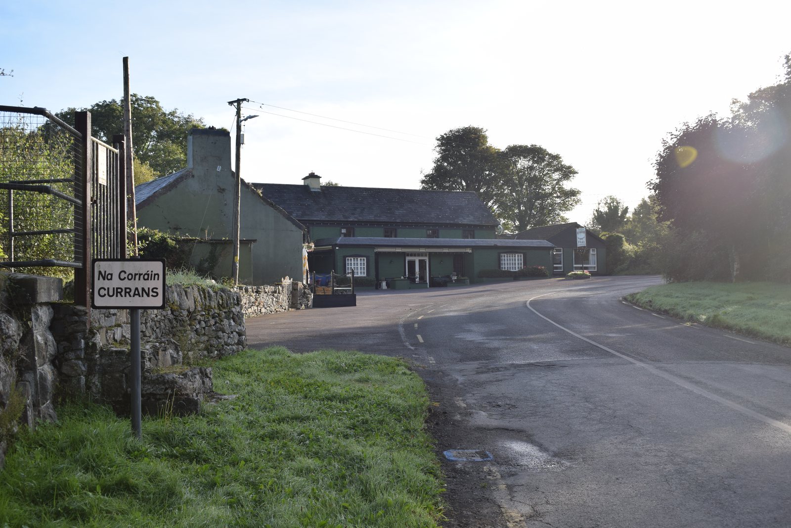 Currans village sign with the village road behind