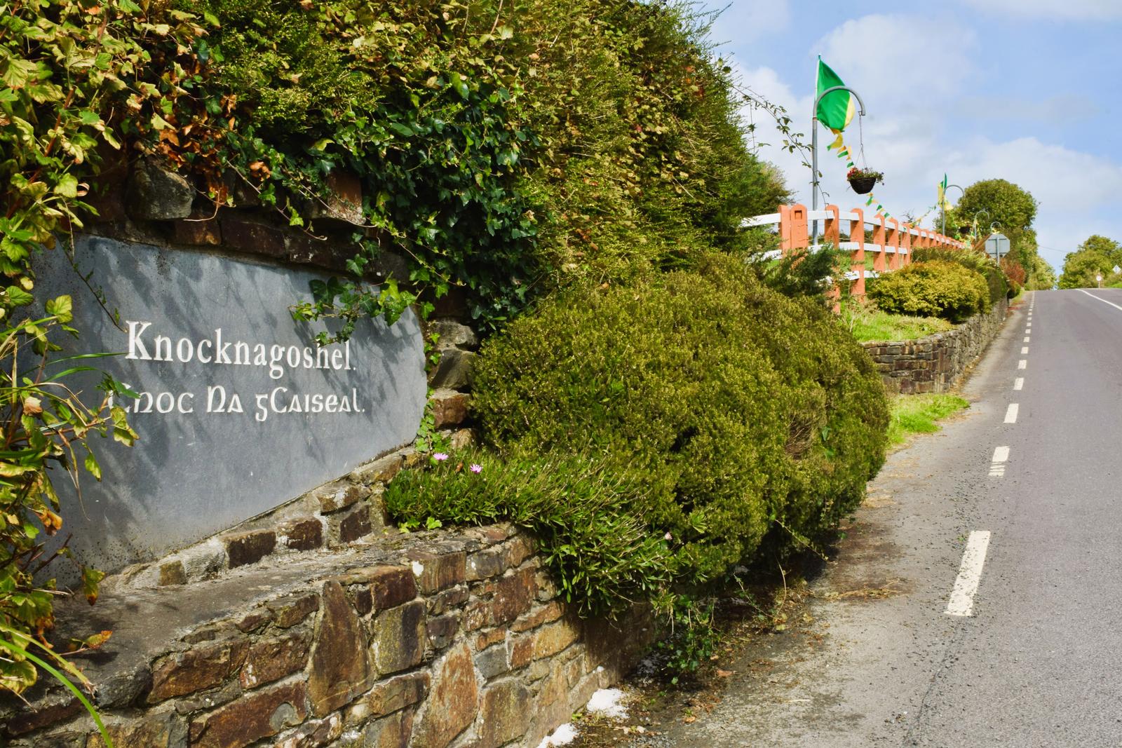 Knocknagoshel village name stone beside the road