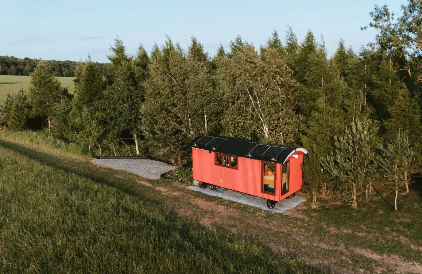 Aerial view of the shepherds hut, showing the idillic, rural location set amongst the trees.