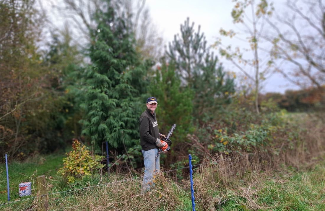Alex Hilton clearing the grounds preparing for the Shepherds Hut