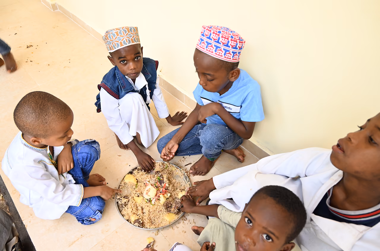 ARCD staff preparing and serving hot meals to displaced families in Sudan