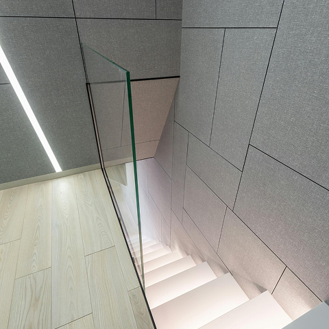 Modern white stairs with glass railing, light wood floor, and gray textured walls.