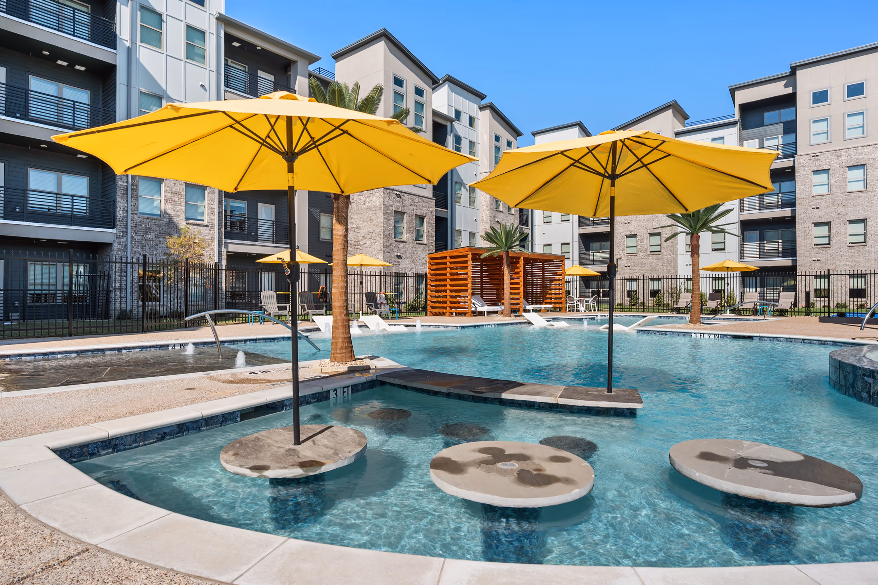 Swimming pool with umbrellas and palm trees