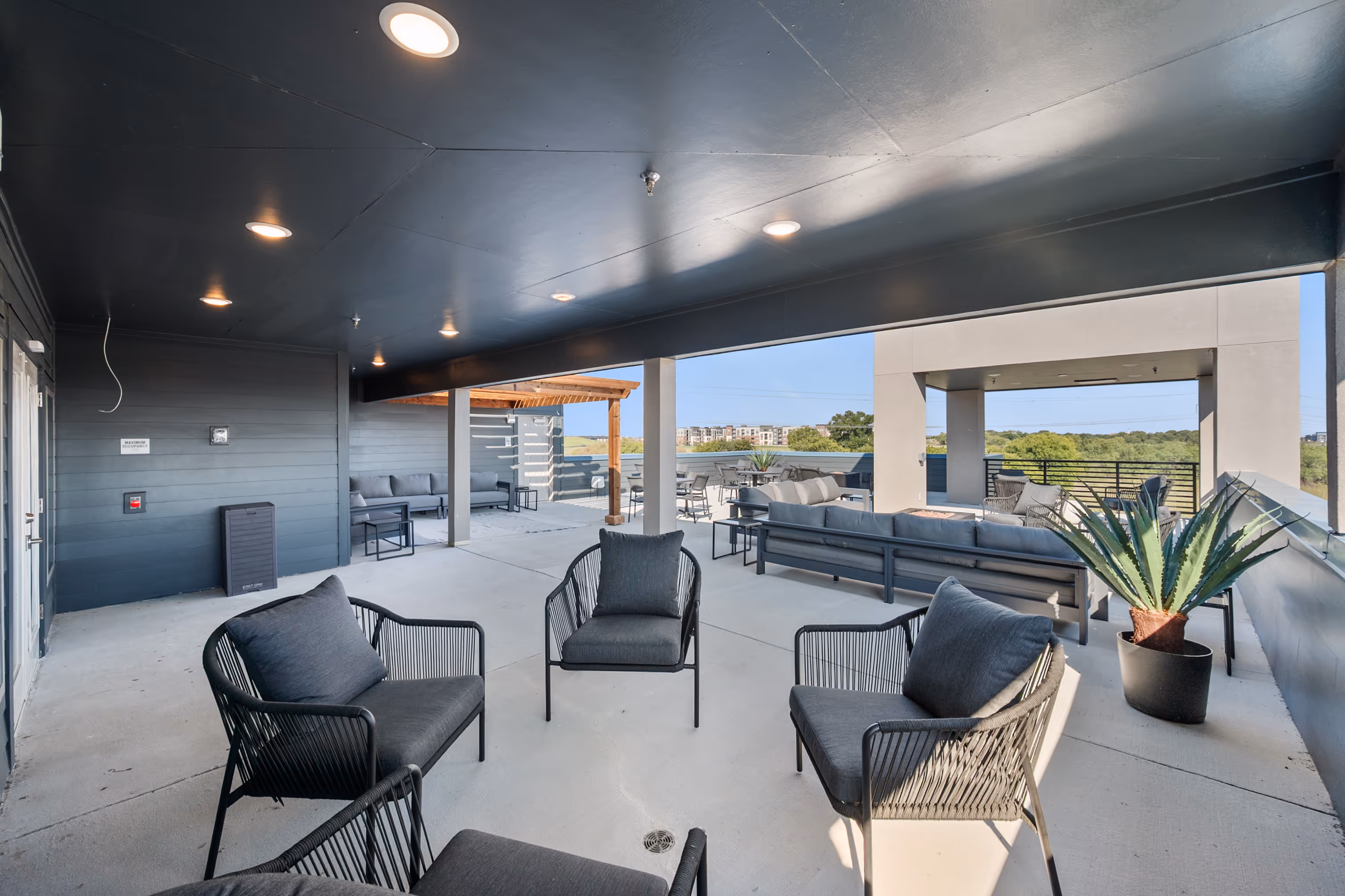 Rooftop outdoor lounge with chairs and sofas