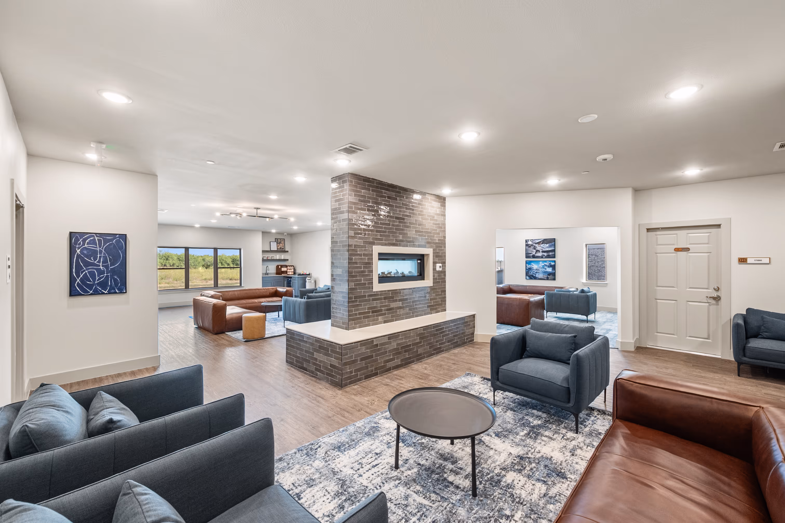 Indoor lounge with sofas, chairs, coffee table, fire place and coffee bar