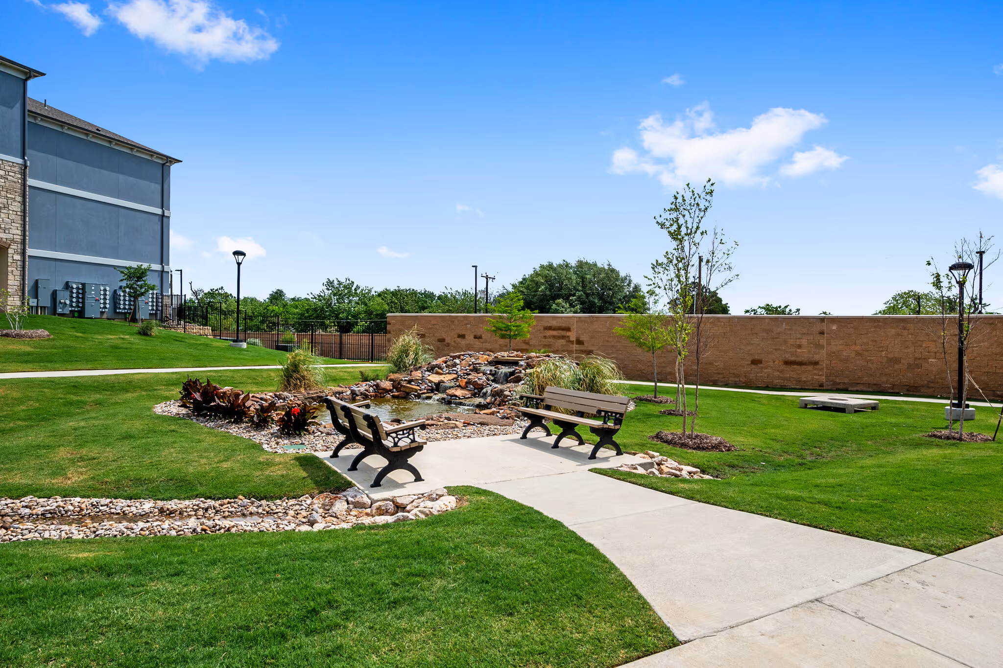 Outdoor pond pond with benches and grassy area