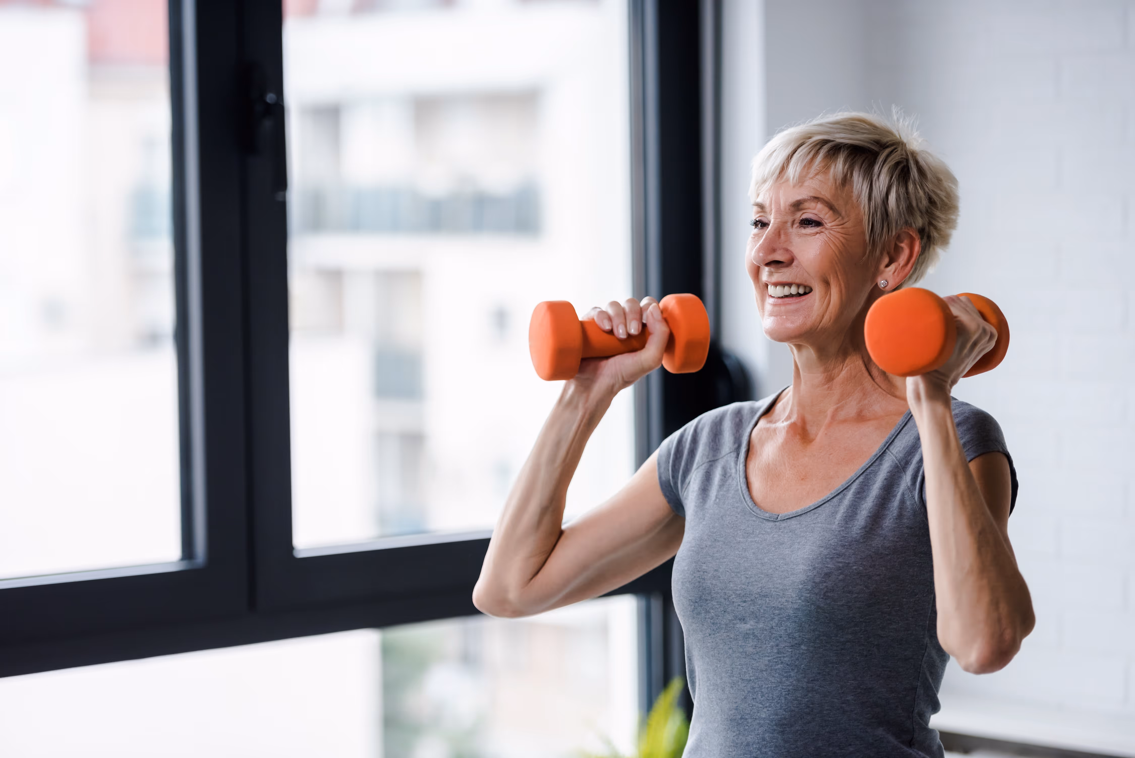 Woman holding weights on her shoulders stock image