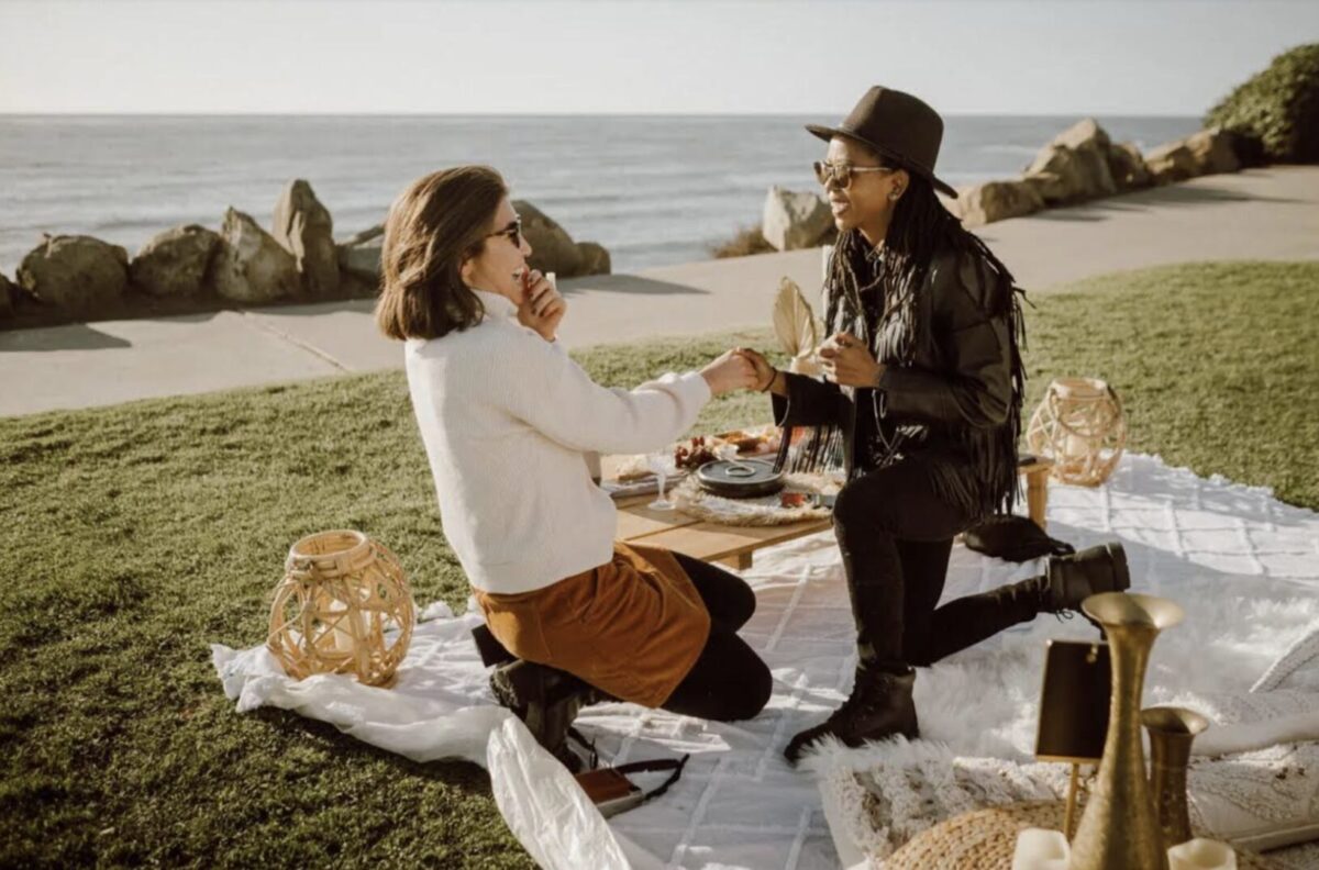 a woman proposing to another woman in a meaningful location