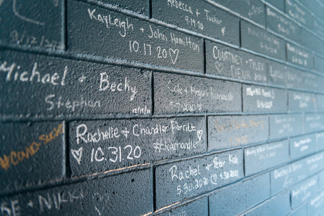 A wall adorned with names, a testament to love and romance at Port 393, a magical venue that emerged amidst the pandemic, offering hope and joy.