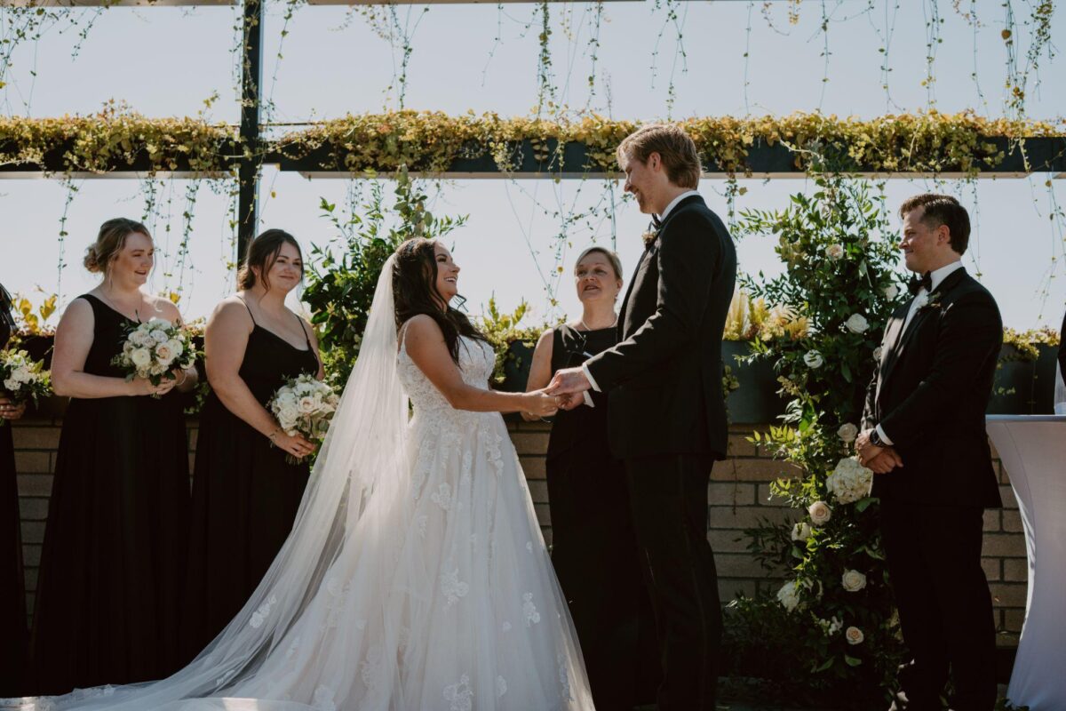 A romantic wedding ceremony at the botanical gardens, surrounded by lush greenery and blooming flowers.