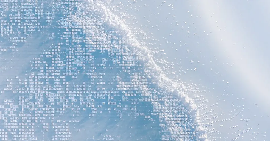 Close-up of frost crystals with geometric patterns on a icy blue surface.