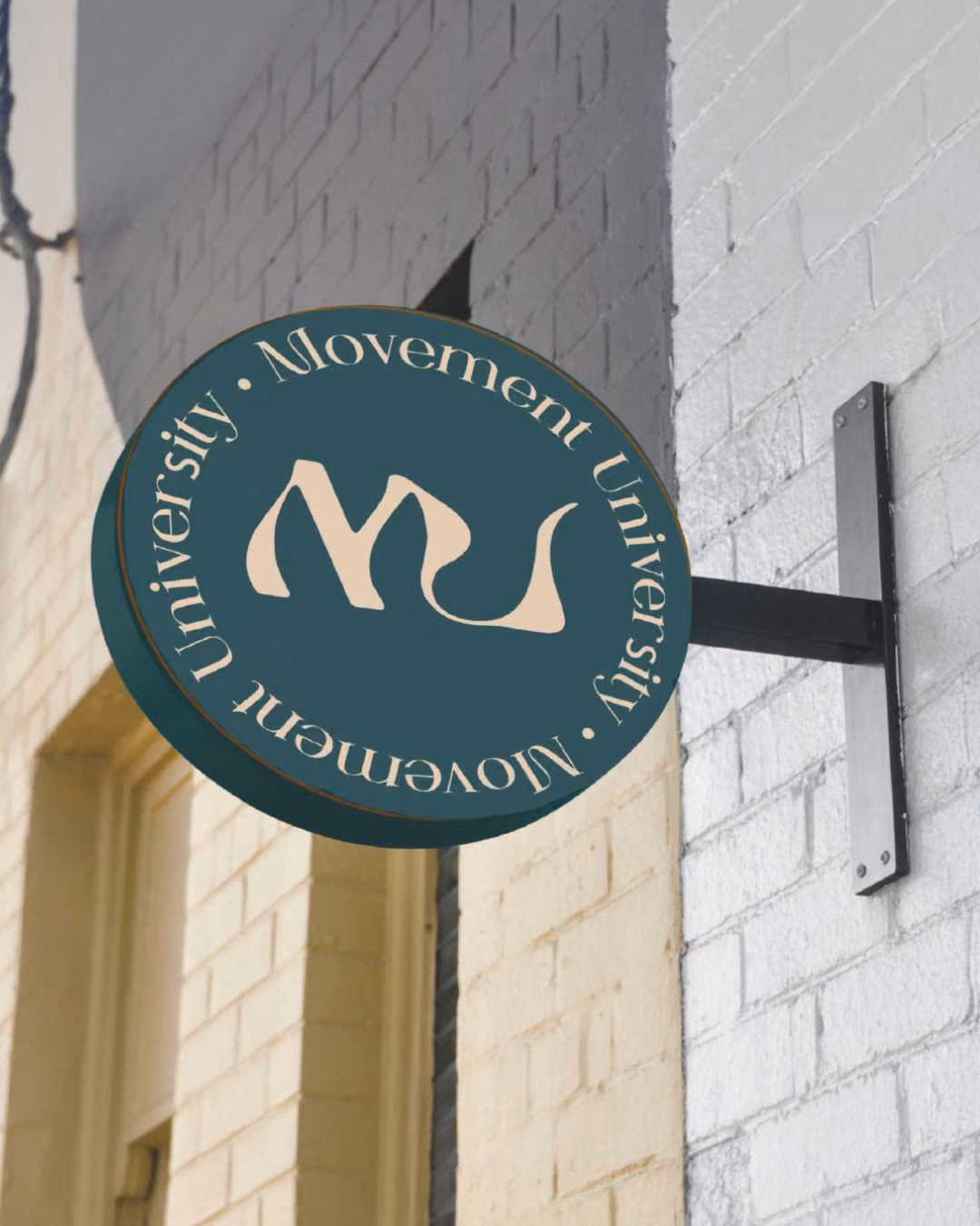 Photo of a sign that include the monogram logo for Movement University