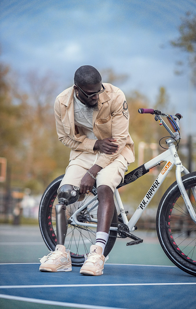 An amputee poses with his prosthetic and mountain bike