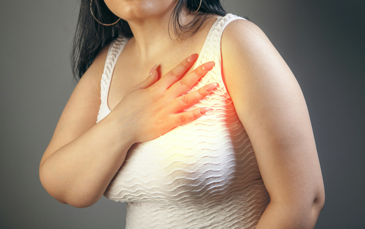 A woman holds her chest