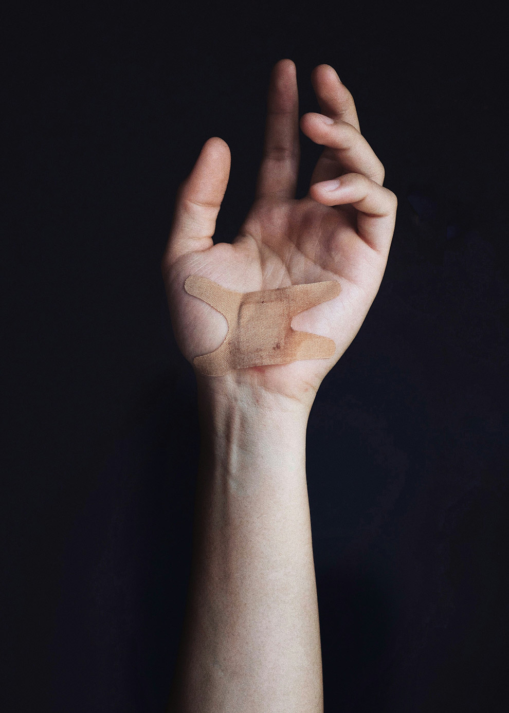 A left hand with a carpal tunnel incision protected by bandage