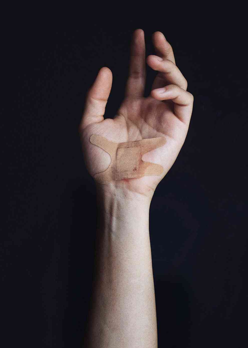 A left hand with a carpal tunnel incision protected by bandage
