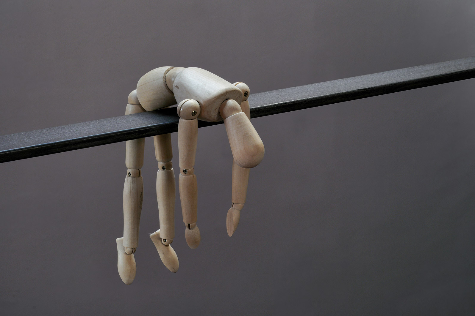 A puppet dangles from a lines helplessly