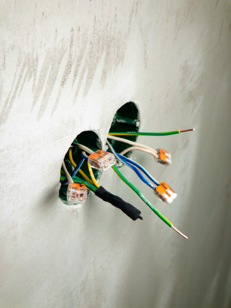 Disconnected wires hanging from a wall