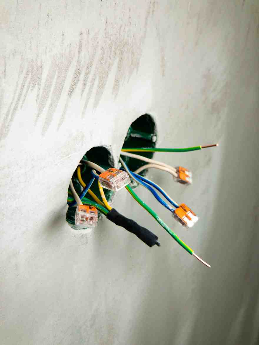 Disconnected wires hanging from a wall