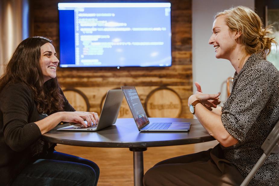 Two people learning how to code