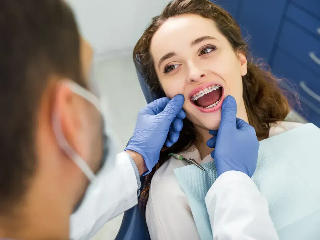 A woman getting her teeth checked by a dentist.