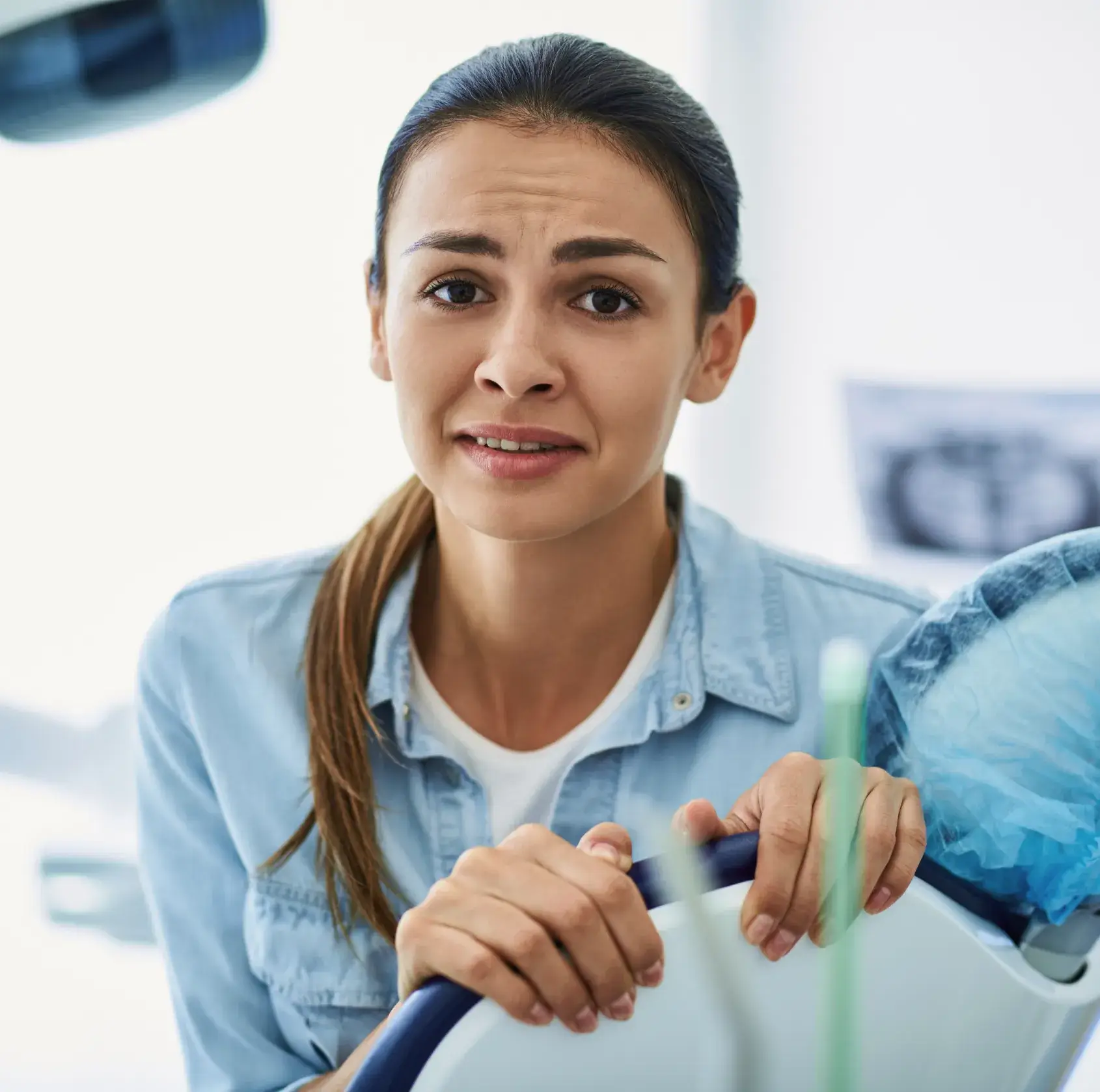 A woman holding a toothbrush in her hand.