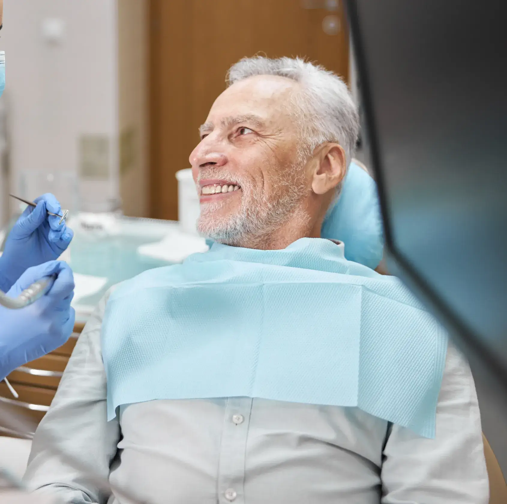 A man sitting in a dentist chair