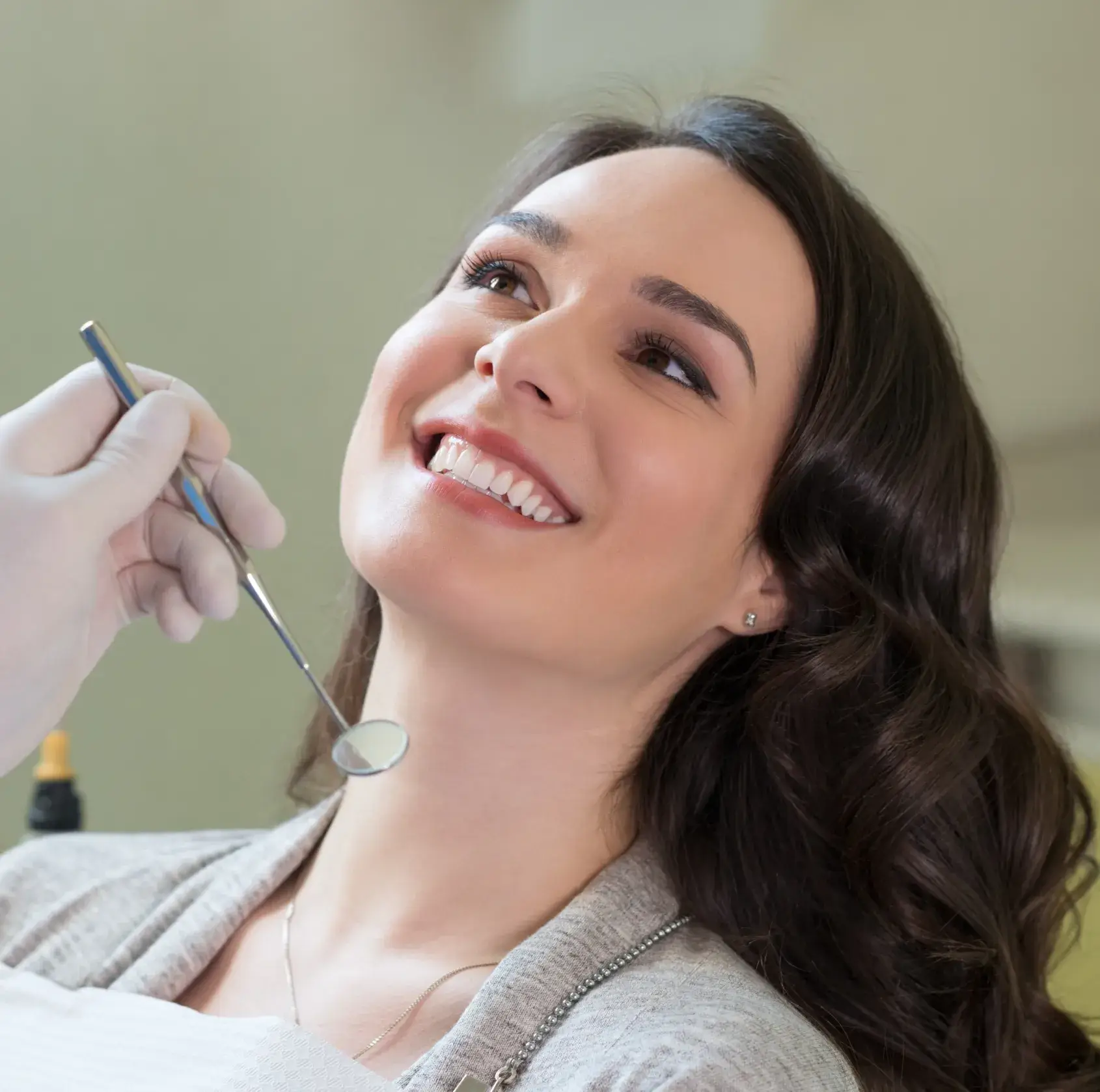 A woman getting her teeth checked by a dentist.